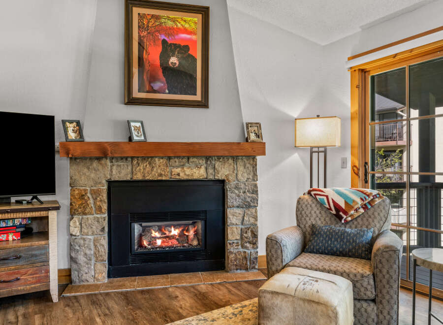 Cozy up by the fireplace in this inviting living space.