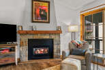 Cozy up by the fireplace in this inviting living space.