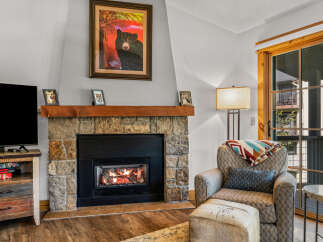 Cozy up by the fireplace in this inviting living space.
