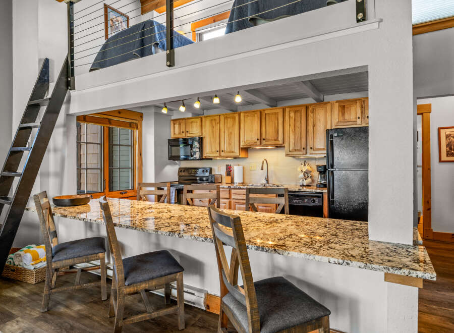 This stunning property boasts a modern kitchen with granite countertops and ample cabinet space, perfect for culinary enthusiasts.