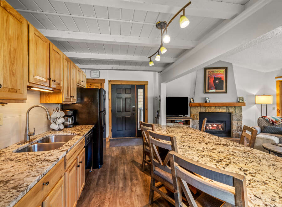 This stunning property boasts a spacious kitchen with granite countertops and ample cabinet space, perfect for culinary enthusiasts.