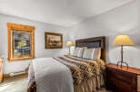 This cozy bedroom features a comfortable bed with a patterned comforter and a stylish headboard.