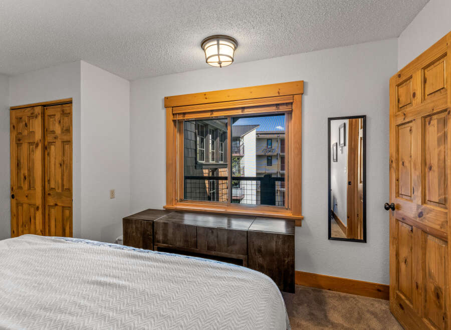 This inviting bedroom features a cozy atmosphere with natural wood accents.