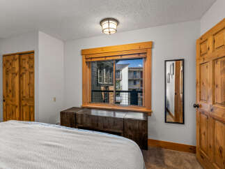 This inviting bedroom features a cozy atmosphere with natural wood accents.