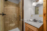 Step into this beautifully designed bathroom featuring a modern shower with glass doors and elegant tile work.