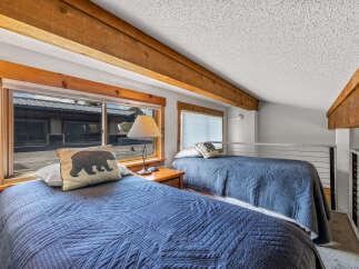 This cozy bedroom features two twin beds, perfect for a guest room or vacation rental.