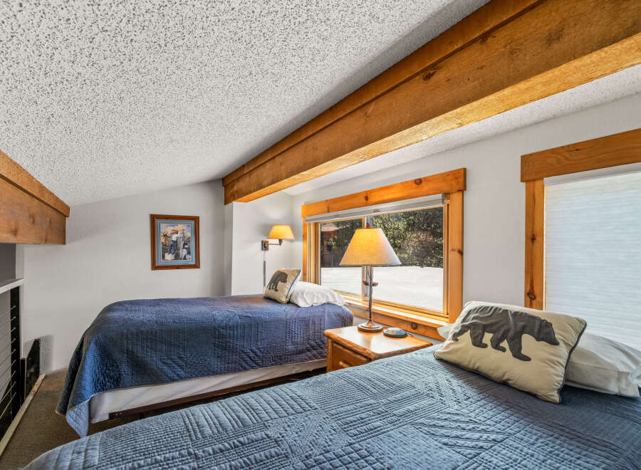 This cozy bedroom features two twin beds, perfect for a guest room or vacation rental.