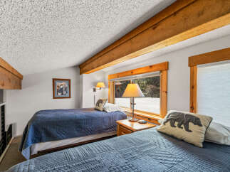 This cozy bedroom features two twin beds, perfect for a guest room or vacation rental.