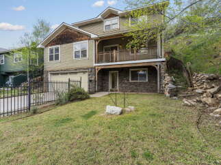 This stunning property boasts a beautiful exterior with a combination of stone and siding, creating a unique and inviting curb appeal.