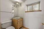 Discover the charm of this well-maintained bathroom, featuring a classic vanity with ample storage and a stylish sink.