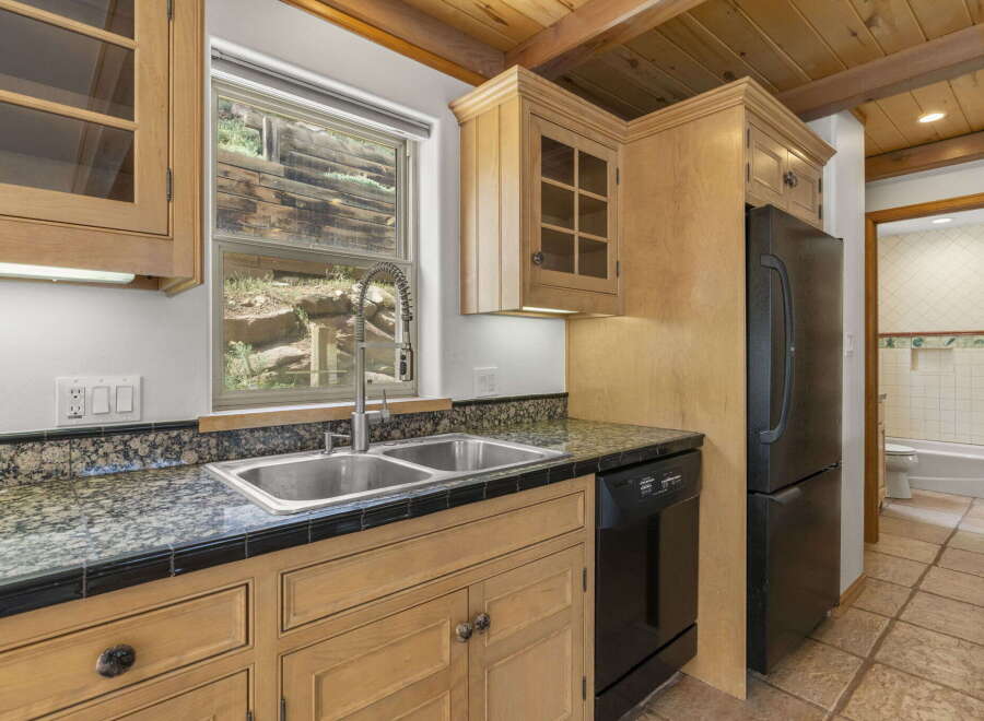 This charming kitchen boasts a rustic aesthetic with its wooden cabinetry and exposed beams.