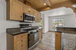 Step into this stunning kitchen, featuring beautiful wooden cabinetry and a modern stainless steel microwave and oven.