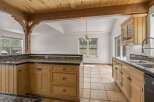 Step into this inviting kitchen, featuring warm wooden cabinetry and a stunning granite countertop.