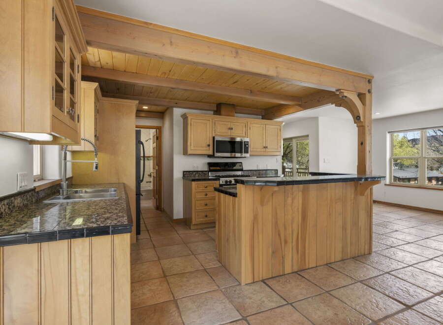 This stunning kitchen boasts custom cabinetry and a unique island design, perfect for both cooking and entertaining.