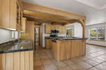 This stunning kitchen boasts custom cabinetry and a unique island design, perfect for both cooking and entertaining.