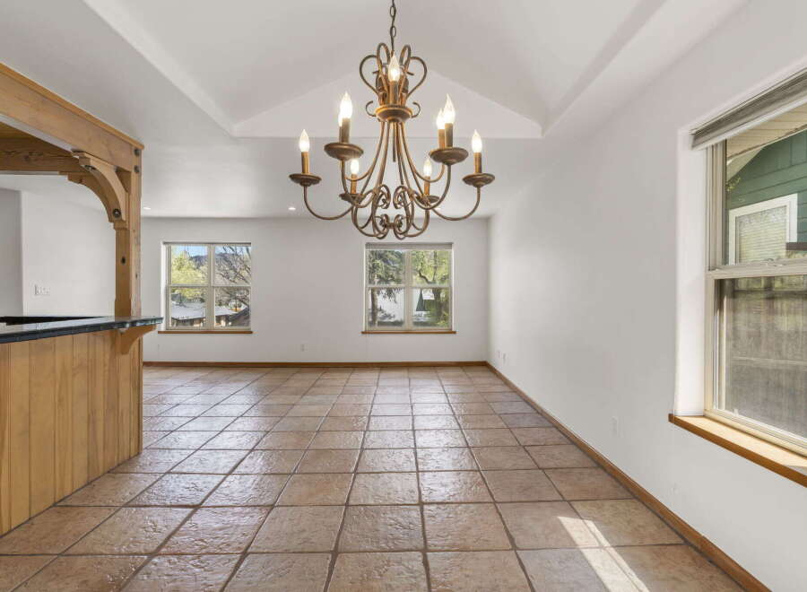 Step into this inviting space, featuring a stunning chandelier and elegant tile flooring.