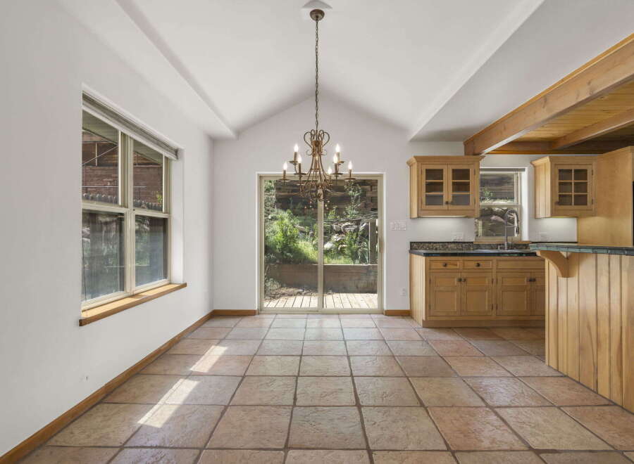 Step into this inviting dining area, featuring a stunning chandelier and a seamless flow to the outdoors.