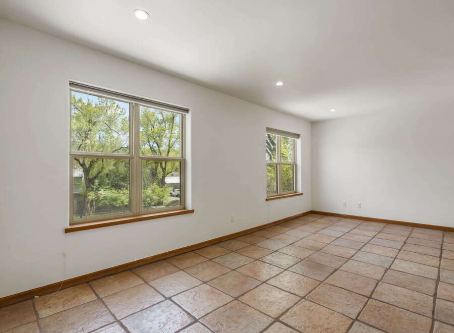 This bright and airy room features large windows that offer stunning views of the surrounding greenery.