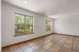 This bright and airy room features large windows that offer stunning views of the surrounding greenery.