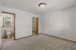Step into this inviting bedroom, featuring a neutral color palette and plush carpeting.
