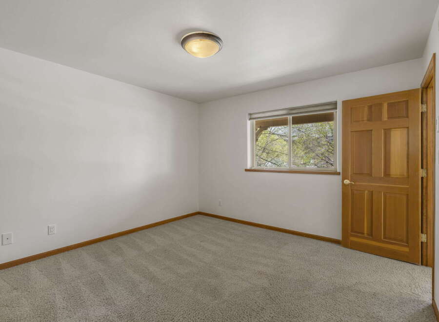 Step into this inviting room featuring a neutral color palette and plush carpeting, creating a cozy atmosphere.