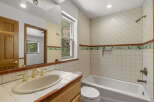 Step into this charming bathroom, featuring a classic design with tiled walls and a cozy atmosphere.