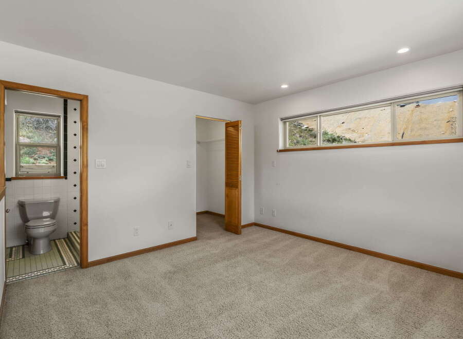 Step into this bright and airy bedroom, featuring a private bathroom and ample closet space.