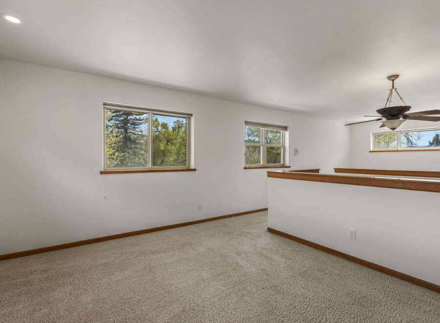 This bright and airy loft space offers a serene retreat with ample natural light.