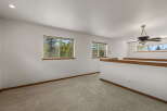 This bright and airy loft space offers a serene retreat with ample natural light.