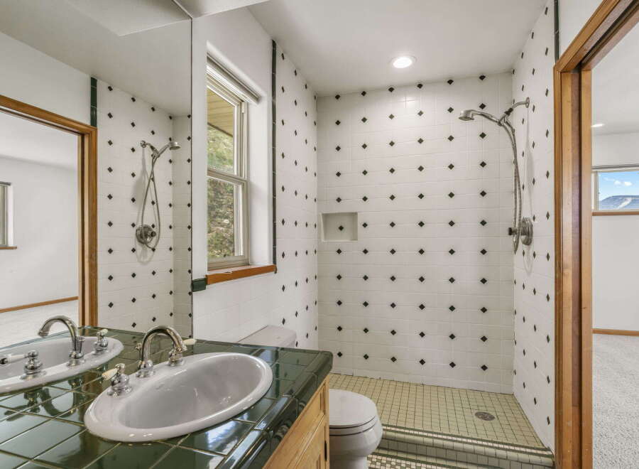 Step into this beautifully designed bathroom featuring a stylish vanity and a spacious shower area.
