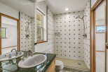 Step into this beautifully designed bathroom featuring a stylish vanity and a spacious shower area.