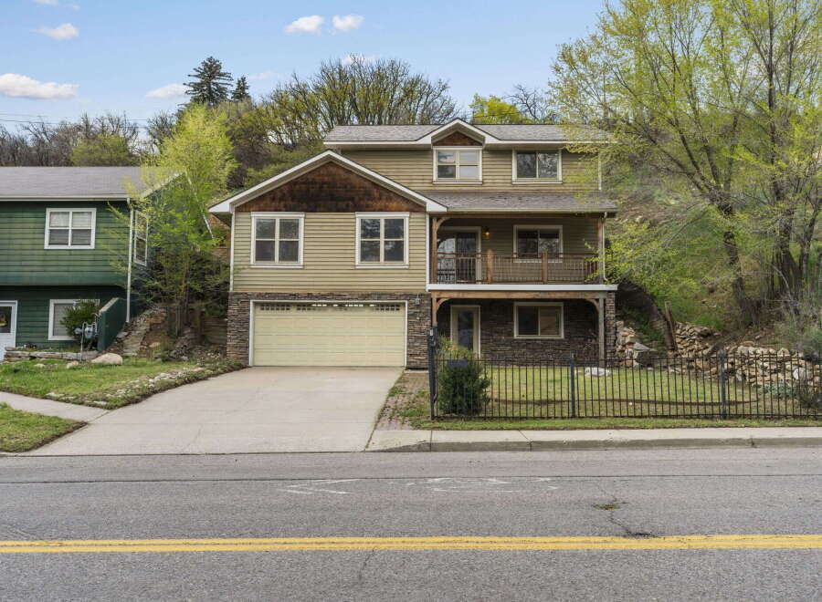 This stunning two-story home boasts a beautiful exterior with a combination of stone and siding, creating a unique and inviting curb appeal.