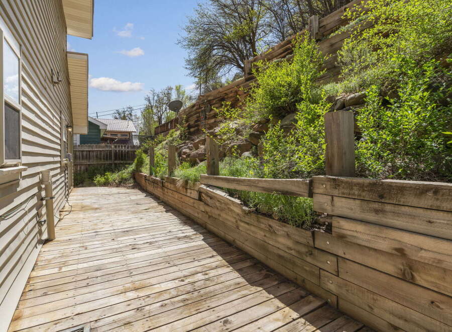 Enjoy outdoor living in this charming property! This home features a spacious wooden deck, perfect for entertaining or relaxing.