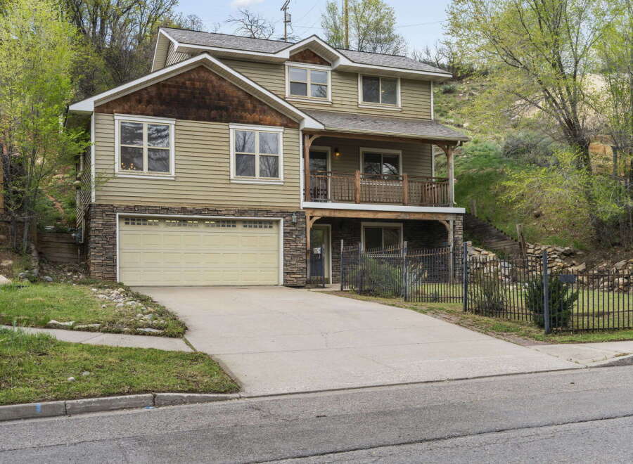 This stunning two-story home boasts a charming exterior with a stone facade and a welcoming porch.