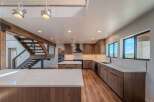 This stunning kitchen boasts a modern design with sleek wooden cabinetry and a spacious island, perfect for culinary enthusiasts.