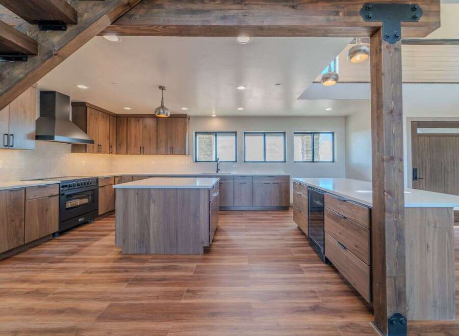 This stunning kitchen boasts a modern design with sleek cabinetry and a spacious layout, perfect for both cooking and entertaining.