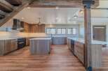 This stunning kitchen boasts a modern design with sleek cabinetry and a spacious layout, perfect for both cooking and entertaining.