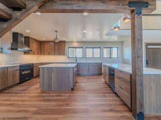 This stunning kitchen boasts a modern design with sleek cabinetry and a spacious layout, perfect for both cooking and entertaining.