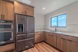 This stunning kitchen boasts modern appliances and elegant wood cabinetry, creating a warm and inviting atmosphere.