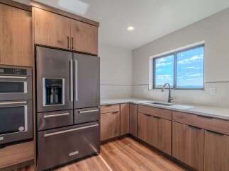 This stunning kitchen boasts modern appliances and elegant wood cabinetry, creating a warm and inviting atmosphere.