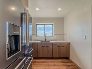 This modern kitchen boasts sleek stainless steel appliances and custom wood cabinetry, creating a stylish and functional space.