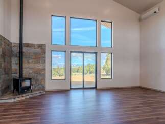 Experience the epitome of modern living in this stunning property, featuring expansive windows that flood the interior with natural light and offer breathtaking views.