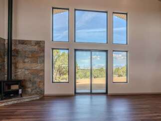 Experience the epitome of modern living in this stunning property, featuring expansive windows that flood the space with natural light.