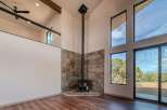 Experience modern luxury in this stunning home featuring a unique fireplace design and expansive windows that flood the space with natural light.