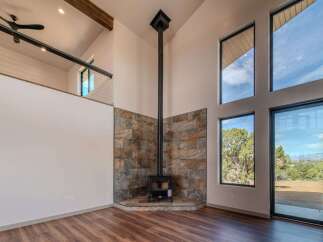 Experience modern luxury in this stunning home featuring a unique fireplace design and expansive windows that flood the space with natural light.