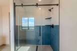 Step into luxury with this stunning bathroom featuring a modern glass shower enclosure.