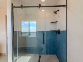 Step into luxury with this stunning bathroom featuring a modern glass shower enclosure.