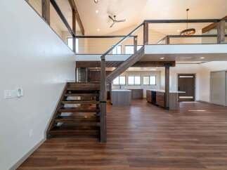 Step into luxury with this stunning property featuring a modern open floor plan and exquisite wooden accents.