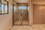 Step into luxury with this stunning bathroom featuring a sleek glass shower enclosure.