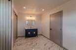 Step into luxury with this stunning bathroom featuring a modern vanity and elegant lighting fixtures.